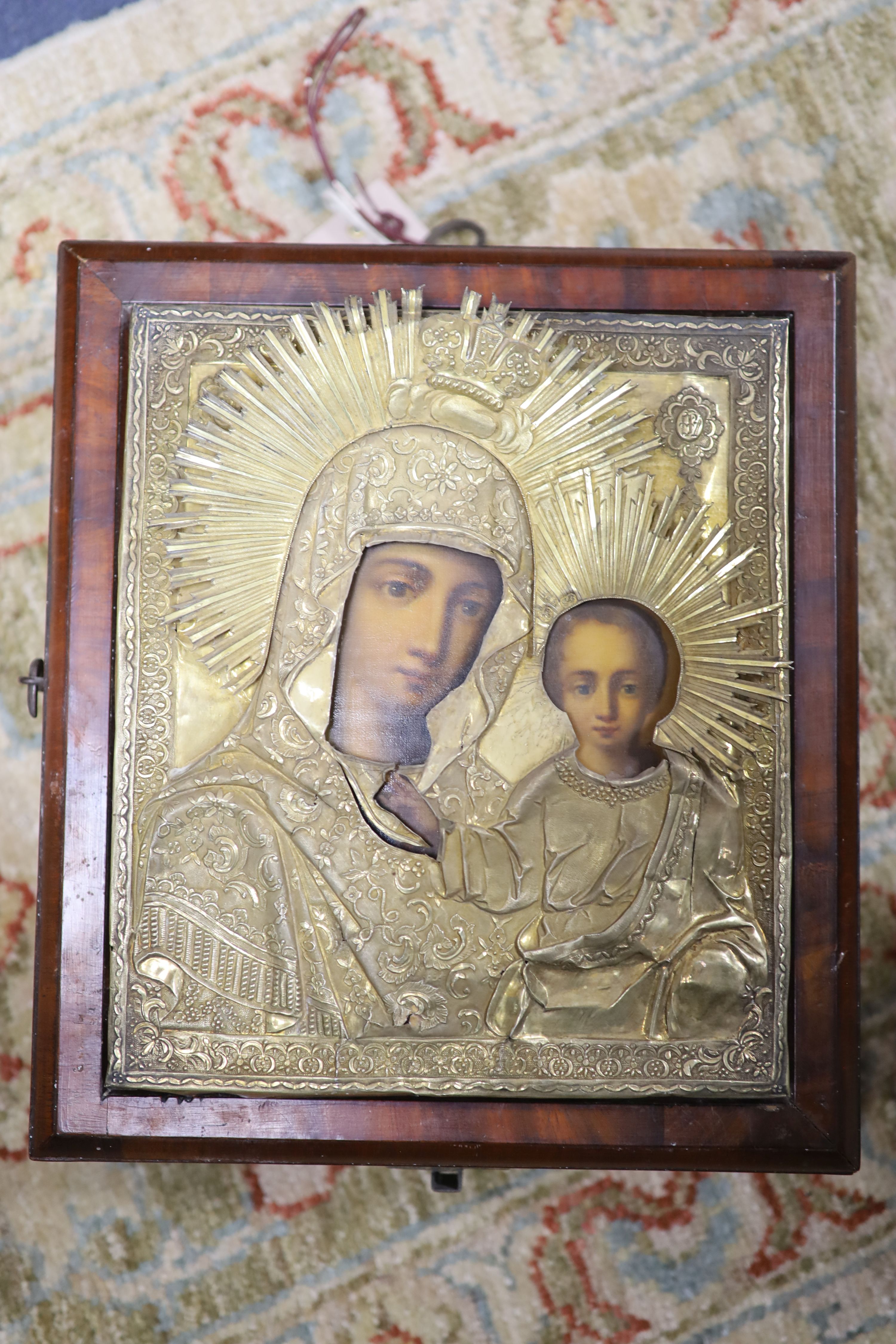 19th Century Russian School. tempera on panel, Icon of the Virgin and Child with silver gilt oklad 23 x 19 cm, case overall 28 x 24cm.